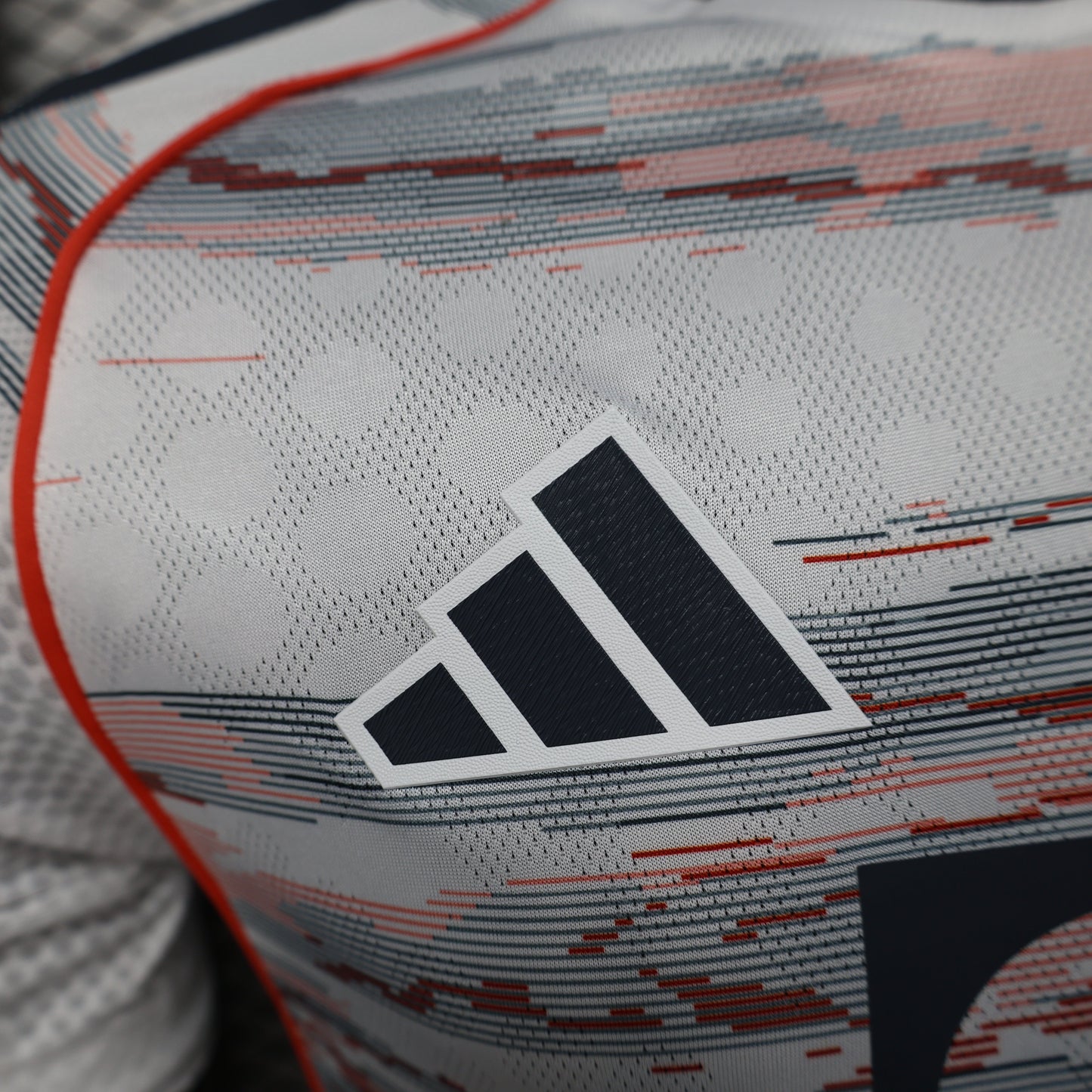 2025/26 Bayern Munich Away Player Version Jersey - White Body Red & Grey Horizontal Brushstroke Graphic - Orange Sleeve Cuffs - Black Adidas Three Stripes - FC Bayern Crest - Deutsche Telekom T Logo