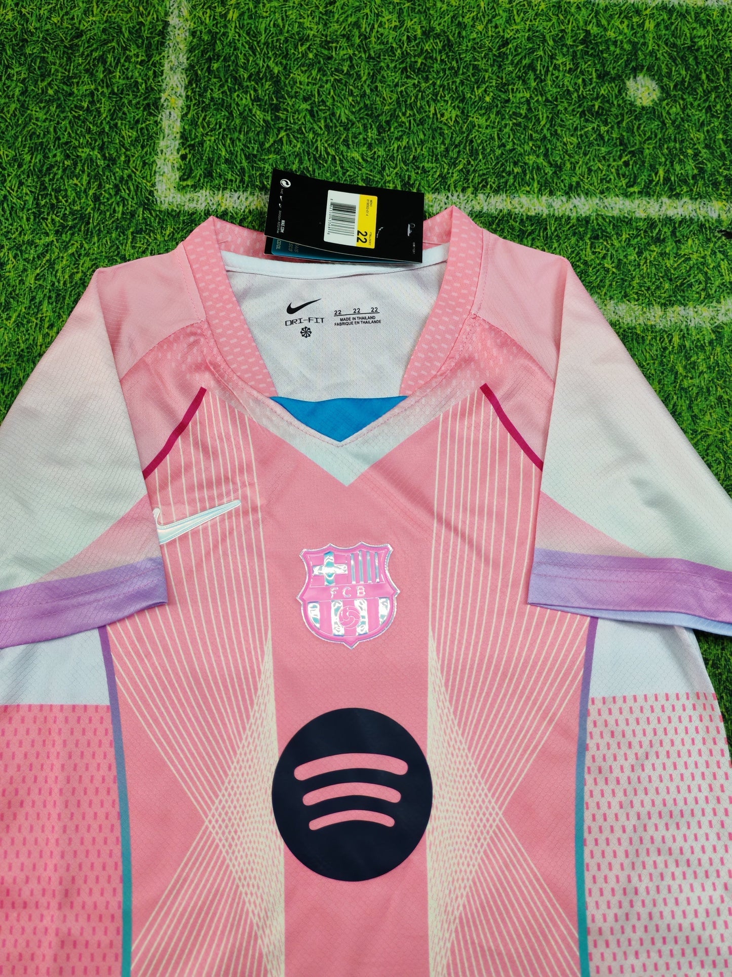 2025/26 FC Barcelona Kids Third Kit Set - Pink Jersey Navy Blue Shorts - Pink Body White Lavender Sleeve Panels Teal V-Neck Geometric Radial Line Texture - White Nike Swoosh - FCB Pink Monochrome Crest - Spotify Navy Blue Sponsor