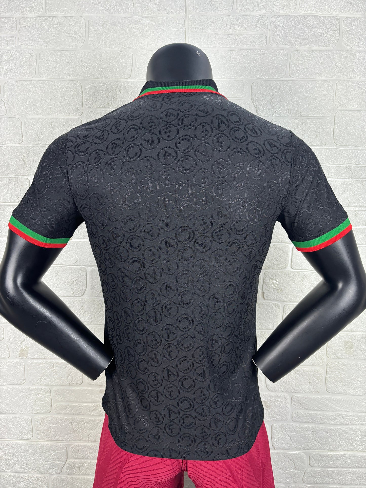 2025/26 Arsenal Special Edition Black Player Version Jersey - Black Body All-Over Tonal Cannon Circular Emboss Pattern Black Polo Collar Green Red Double Stripe Trim - Green Three Stripes - Red Arsenal Cannon Crest - Emirates Fly Better