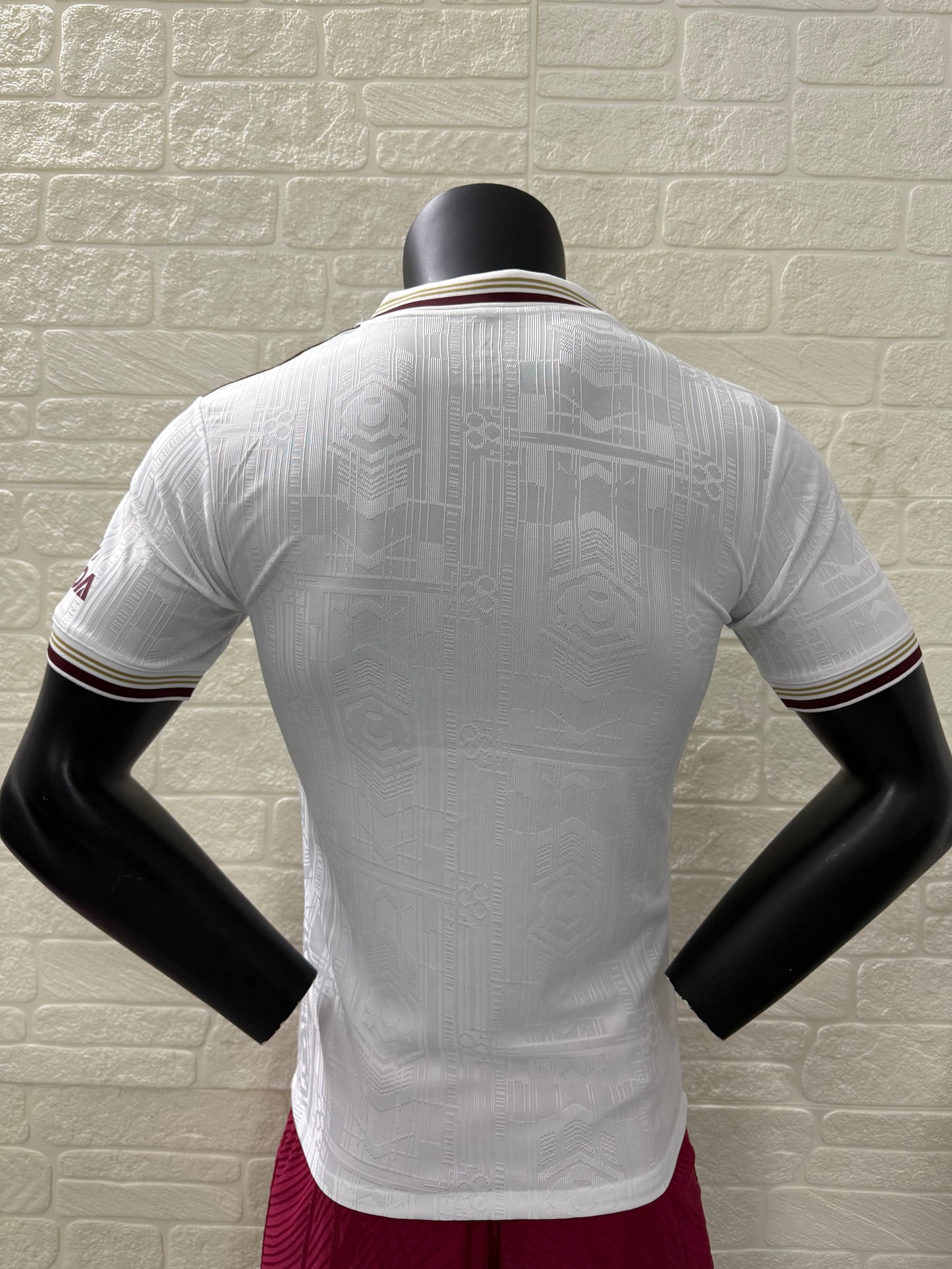 2025/26 Arsenal Third Player Version Jersey - White Body All-Over Subtle Tonal Graphic Texture Deep Maroon Polo Collar Gold Cream Stripe Trim Deep Maroon Sleeve Cuff Trim - Originals Trefoil - Arsenal Cannon Crest - Emirates Fly Better