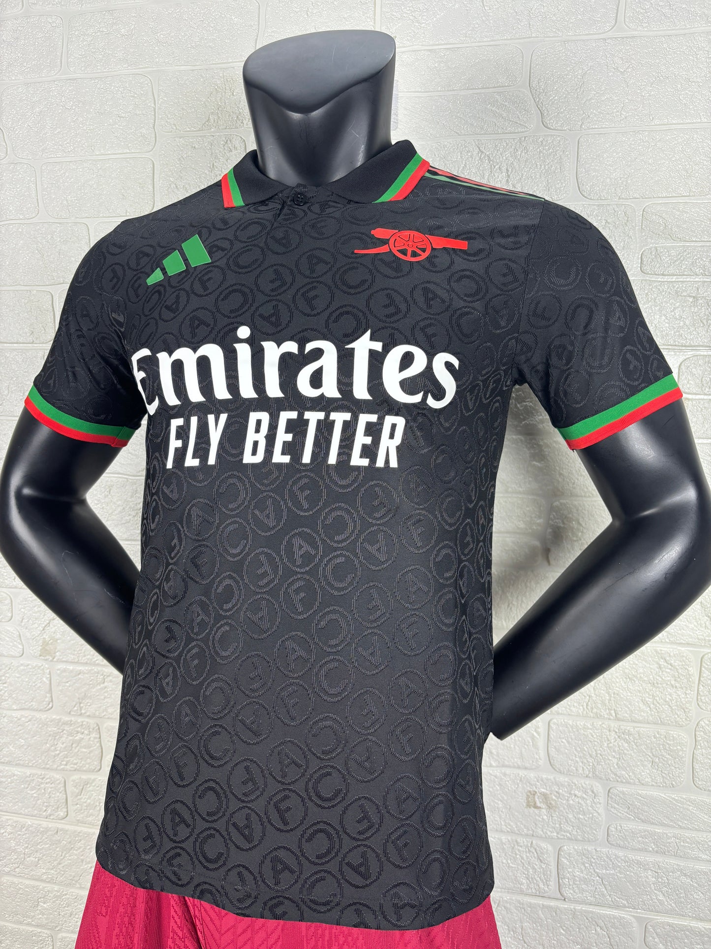 2025/26 Arsenal Special Edition Black Player Version Jersey - Black Body All-Over Tonal Cannon Circular Emboss Pattern Black Polo Collar Green Red Double Stripe Trim - Green Three Stripes - Red Arsenal Cannon Crest - Emirates Fly Better
