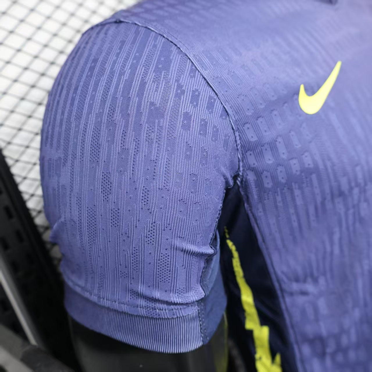 2025/26 Atlético Madrid Away Player Version Jersey - Deep Purple-Navy Body All-Over Subtle Geometric Tonal Texture Deep Purple-Navy V-Neck Collar - Nike Volt Yellow-Green Swoosh - Atlético Madrid Official Shield Crest Volt Yellow-Green