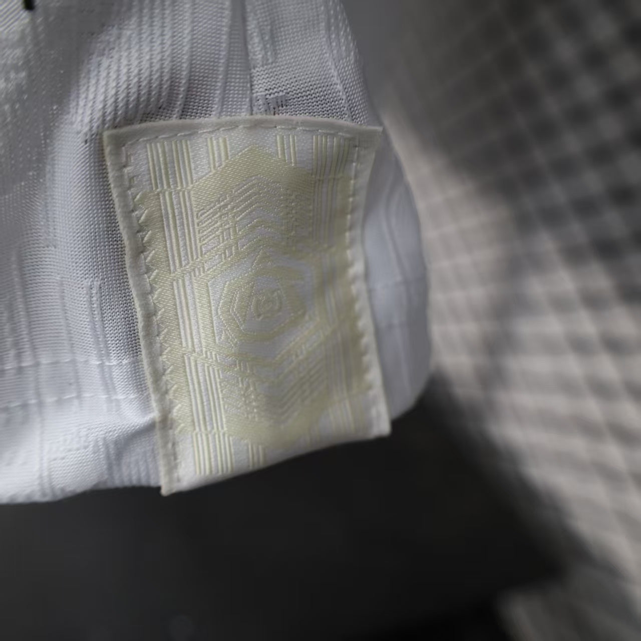 2025/26 Arsenal Away Player Version Jersey - White Body All-Over Subtle Tonal Graphic Texture Deep Maroon Polo Collar Gold Cream Stripe Trim - Originals Trefoil - Arsenal Cannon Crest - Emirates Fly Better - Men's