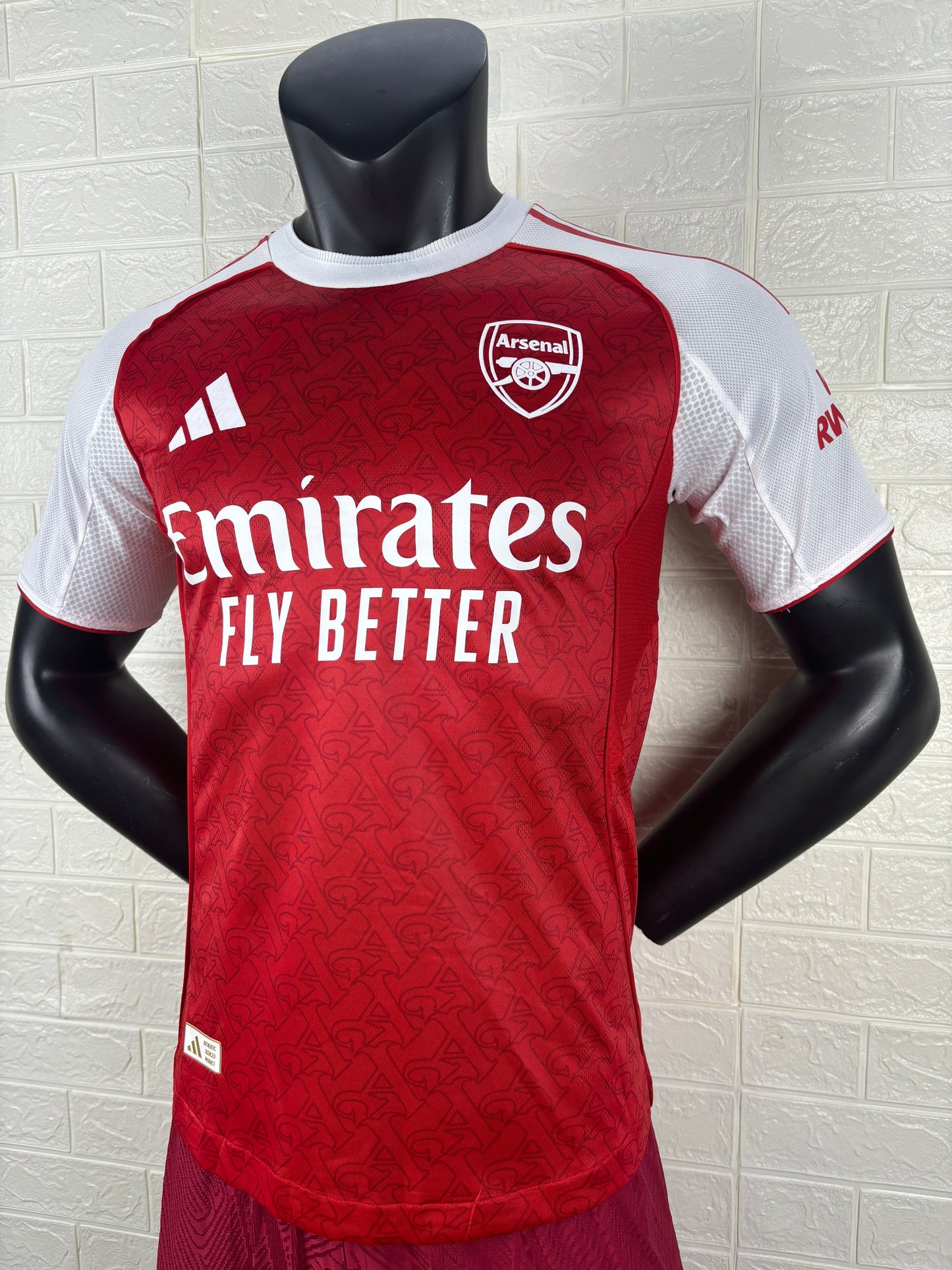 2025/26 Arsenal Home Player Version Jersey - Red Body White Sleeves Diamond Mesh Texture Red Side Seam Piping - White Three Stripes Left Chest - Arsenal Shield Crest Right Chest - Emirates Fly Better Principal Sponsor
