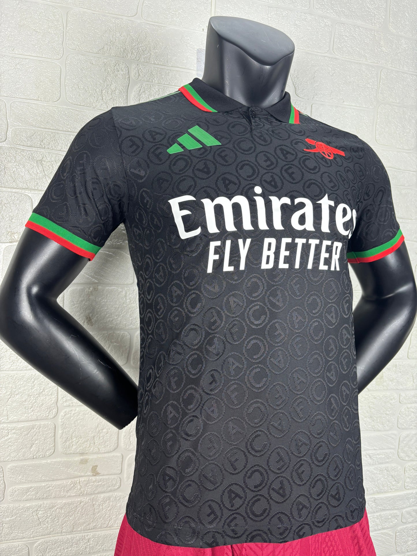 2025/26 Arsenal Special Edition Black Player Version Jersey - Black Body All-Over Tonal Cannon Circular Emboss Pattern Black Polo Collar Green Red Double Stripe Trim - Green Three Stripes - Red Arsenal Cannon Crest - Emirates Fly Better
