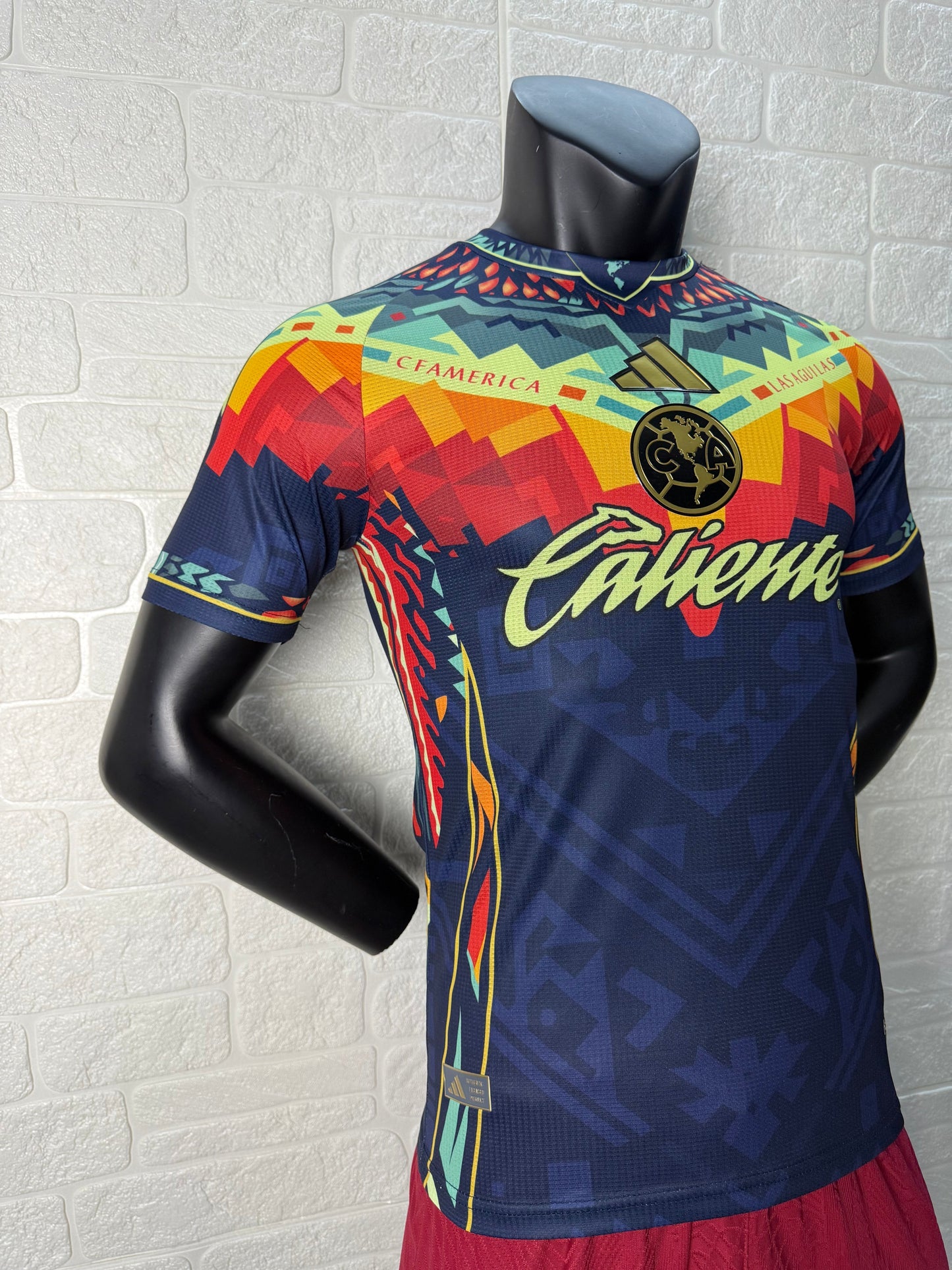 2025/26 Club América Training Player Version Jersey - Dark Navy Blue Body Multicolour Aztec Zigzag Graphic Upper Chest -Gold Three Stripes - Club América Crest - Caliente Principal Sponsor