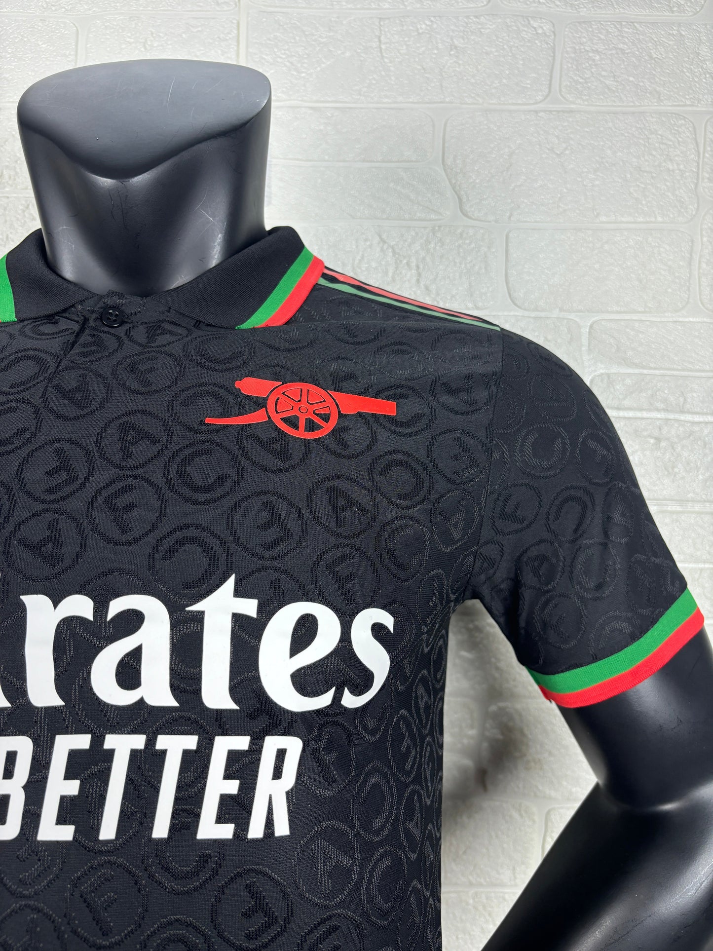 2025/26 Arsenal Special Edition Black Player Version Jersey - Black Body All-Over Tonal Cannon Circular Emboss Pattern Black Polo Collar Green Red Double Stripe Trim - Green Three Stripes - Red Arsenal Cannon Crest - Emirates Fly Better