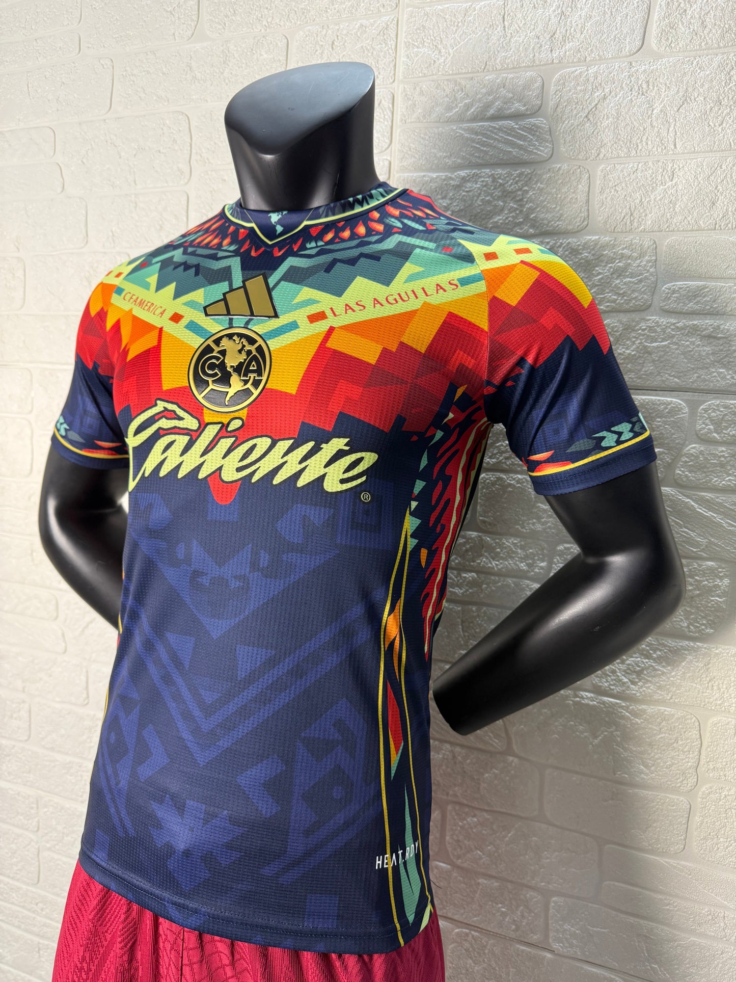 2025/26 Club América Training Player Version Jersey - Dark Navy Blue Body Multicolour Aztec Zigzag Graphic Upper Chest -Gold Three Stripes - Club América Crest - Caliente Principal Sponsor