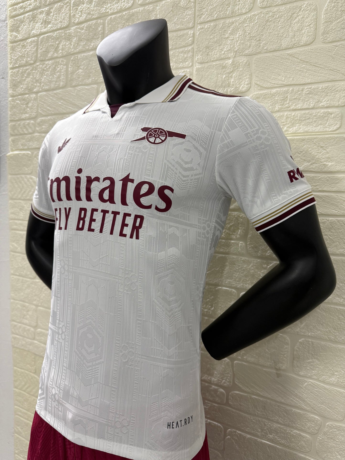 2025/26 Arsenal Third Player Version Jersey - White Body All-Over Subtle Tonal Graphic Texture Deep Maroon Polo Collar Gold Cream Stripe Trim Deep Maroon Sleeve Cuff Trim - Originals Trefoil - Arsenal Cannon Crest - Emirates Fly Better
