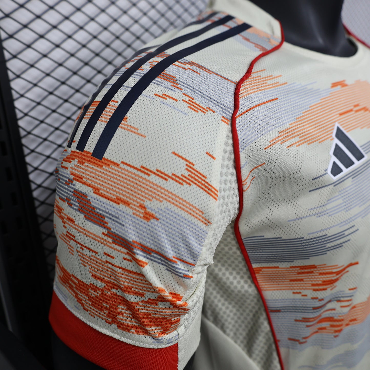 2025/26 Bayern Munich Away Player Version Jersey -  Body Orange Grey Horizontal Brush Stroke Graphic  - Red Side Seam Piping Red Sleeve Cuffs Black Shoulder Stripes - FC Bayern Crest - Deutsche Telekom T Logo