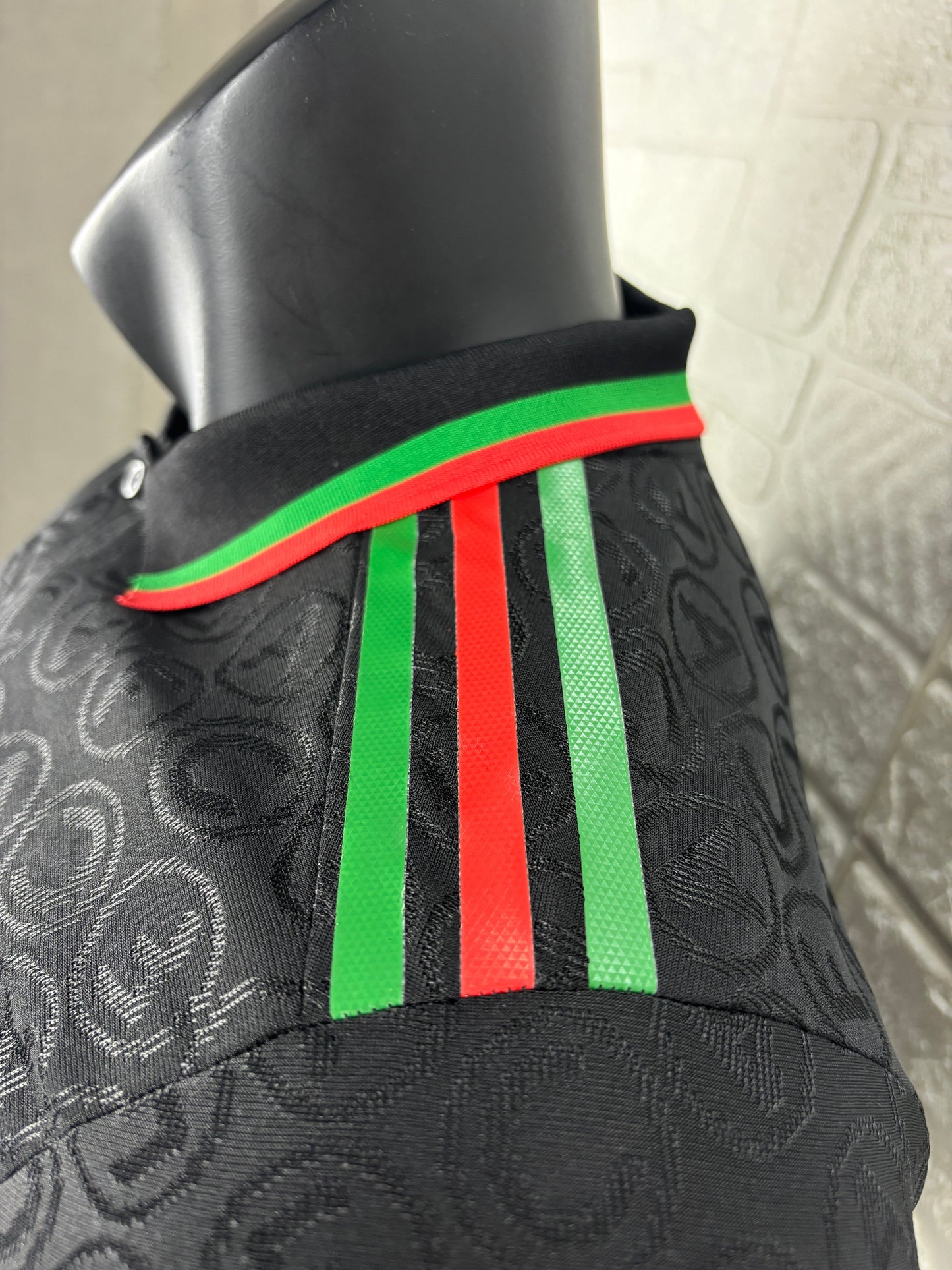 2025/26 Arsenal Special Edition Black Player Version Jersey - Black Body All-Over Tonal Cannon Circular Emboss Pattern Black Polo Collar Green Red Double Stripe Trim - Green Three Stripes - Red Arsenal Cannon Crest - Emirates Fly Better