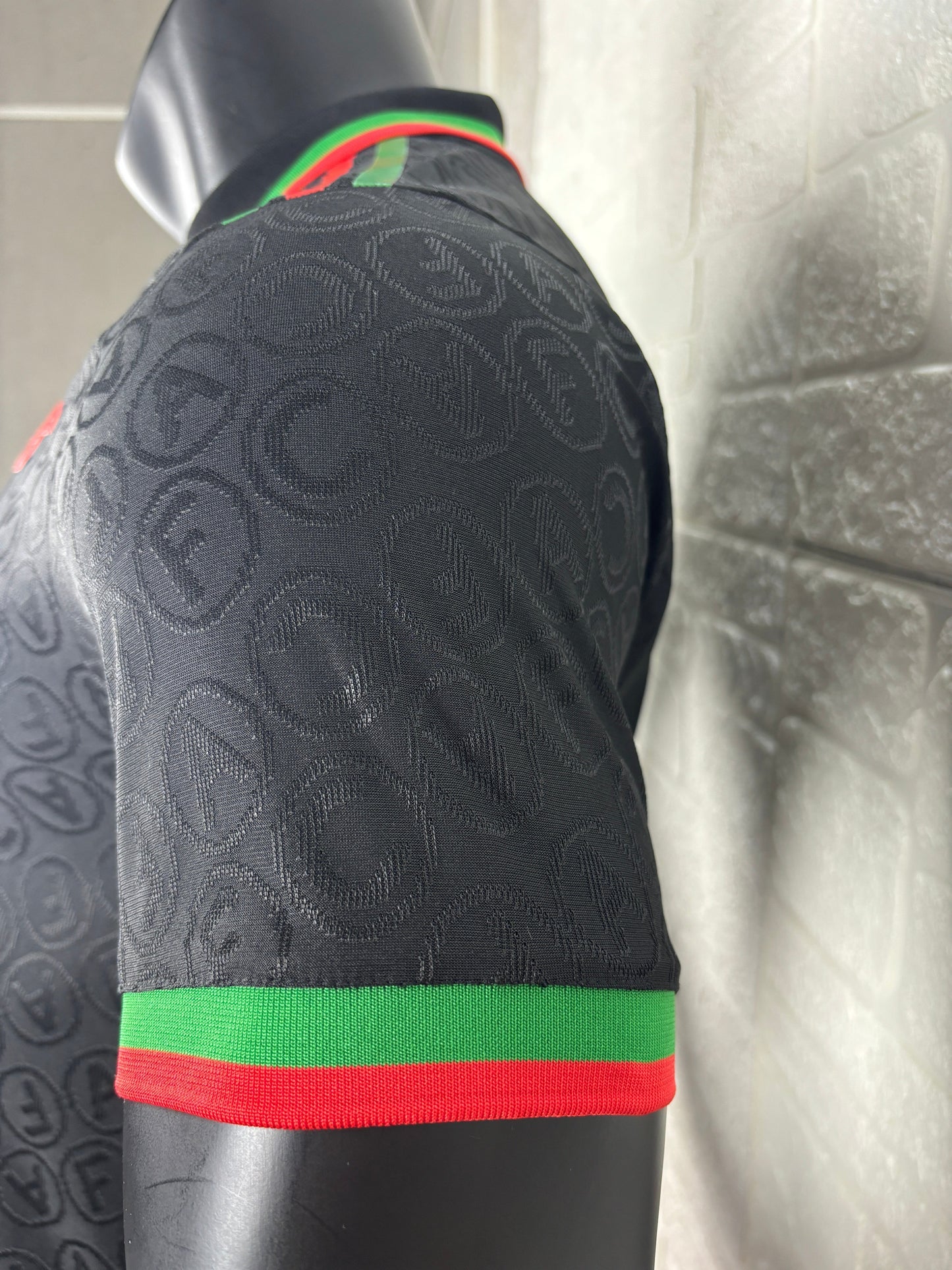 2025/26 Arsenal Special Edition Black Player Version Jersey - Black Body All-Over Tonal Cannon Circular Emboss Pattern Black Polo Collar Green Red Double Stripe Trim - Green Three Stripes - Red Arsenal Cannon Crest - Emirates Fly Better