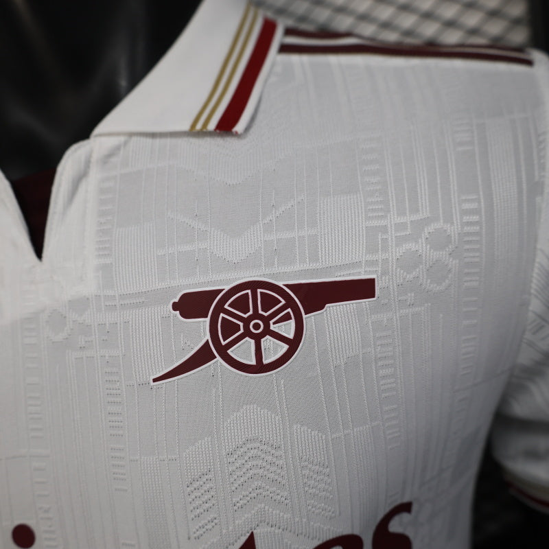 2025/26 Arsenal Away Player Version Jersey - White Body All-Over Subtle Tonal Graphic Texture Deep Maroon Polo Collar Multi-Stripe Gold Red White Trim - Originals Trefoil - Arsenal Cannon Crest - Emirates Fly Better - Men's