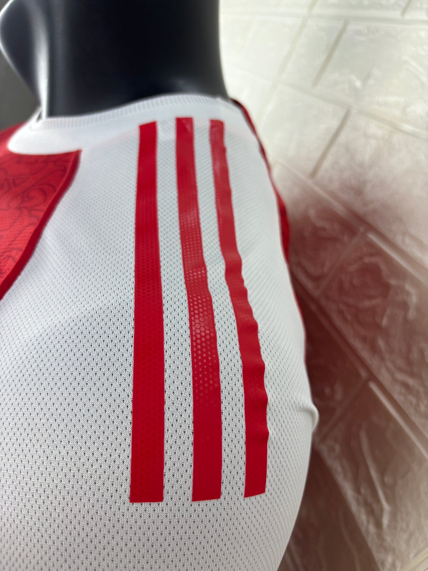 2025/26 Arsenal Home Player Version Jersey - Red Body White Sleeves Diamond Mesh Texture Red Side Seam Piping - White Three Stripes Left Chest - Arsenal Shield Crest Right Chest - Emirates Fly Better Principal Sponsor