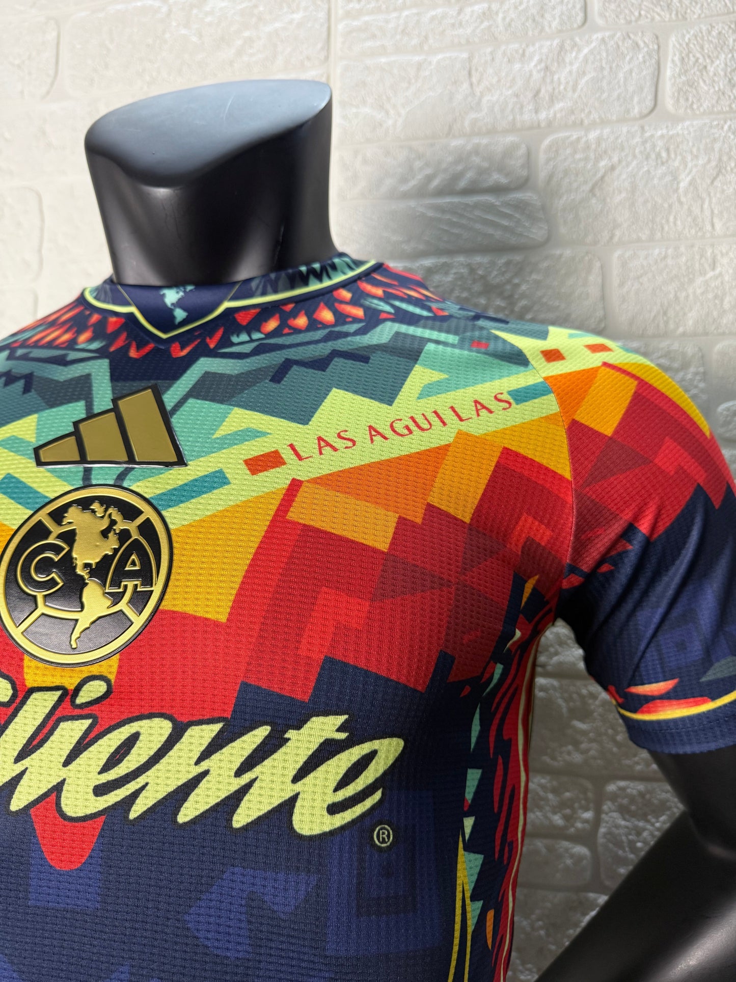 2025/26 Club América Training Player Version Jersey - Dark Navy Blue Body Multicolour Aztec Zigzag Graphic Upper Chest -Gold Three Stripes - Club América Crest - Caliente Principal Sponsor