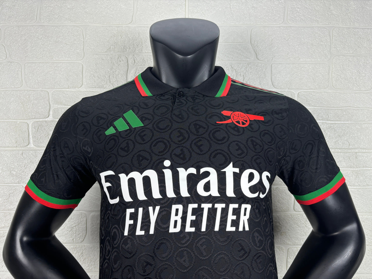 2025/26 Arsenal Special Edition Black Player Version Jersey - Black Body All-Over Tonal Cannon Circular Emboss Pattern Black Polo Collar Green Red Double Stripe Trim - Green Three Stripes - Red Arsenal Cannon Crest - Emirates Fly Better