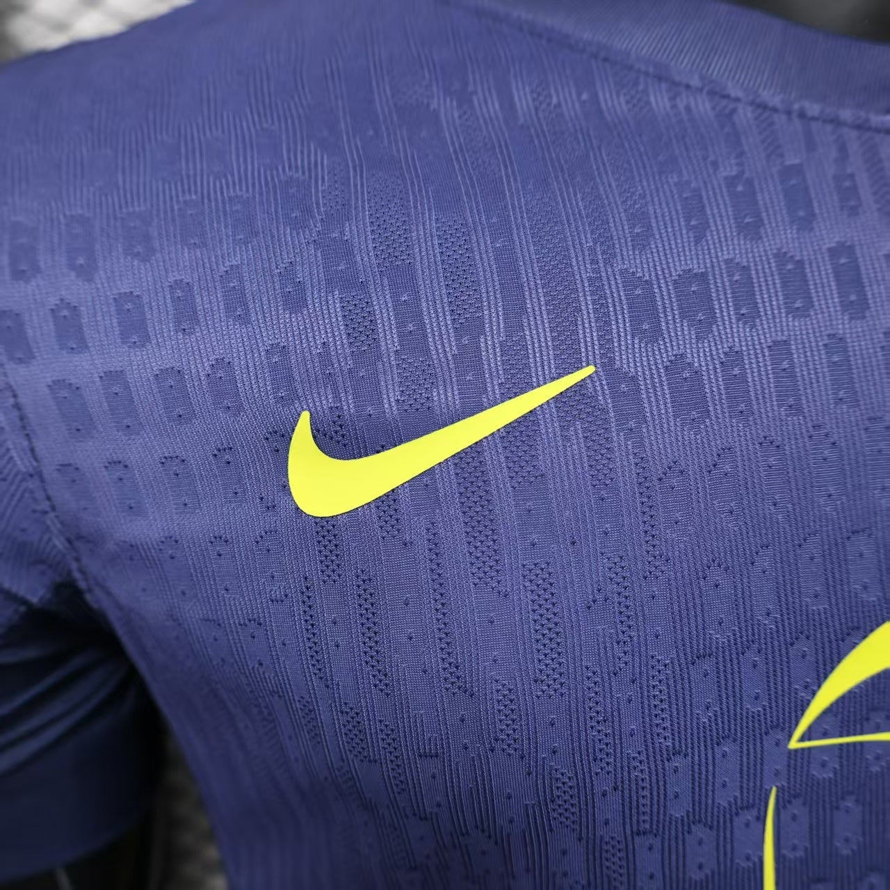 2025/26 Atlético Madrid Away Player Version Jersey - Deep Purple-Navy Body All-Over Subtle Geometric Tonal Texture Deep Purple-Navy V-Neck Collar - Nike Volt Yellow-Green Swoosh - Atlético Madrid Official Shield Crest Volt Yellow-Green