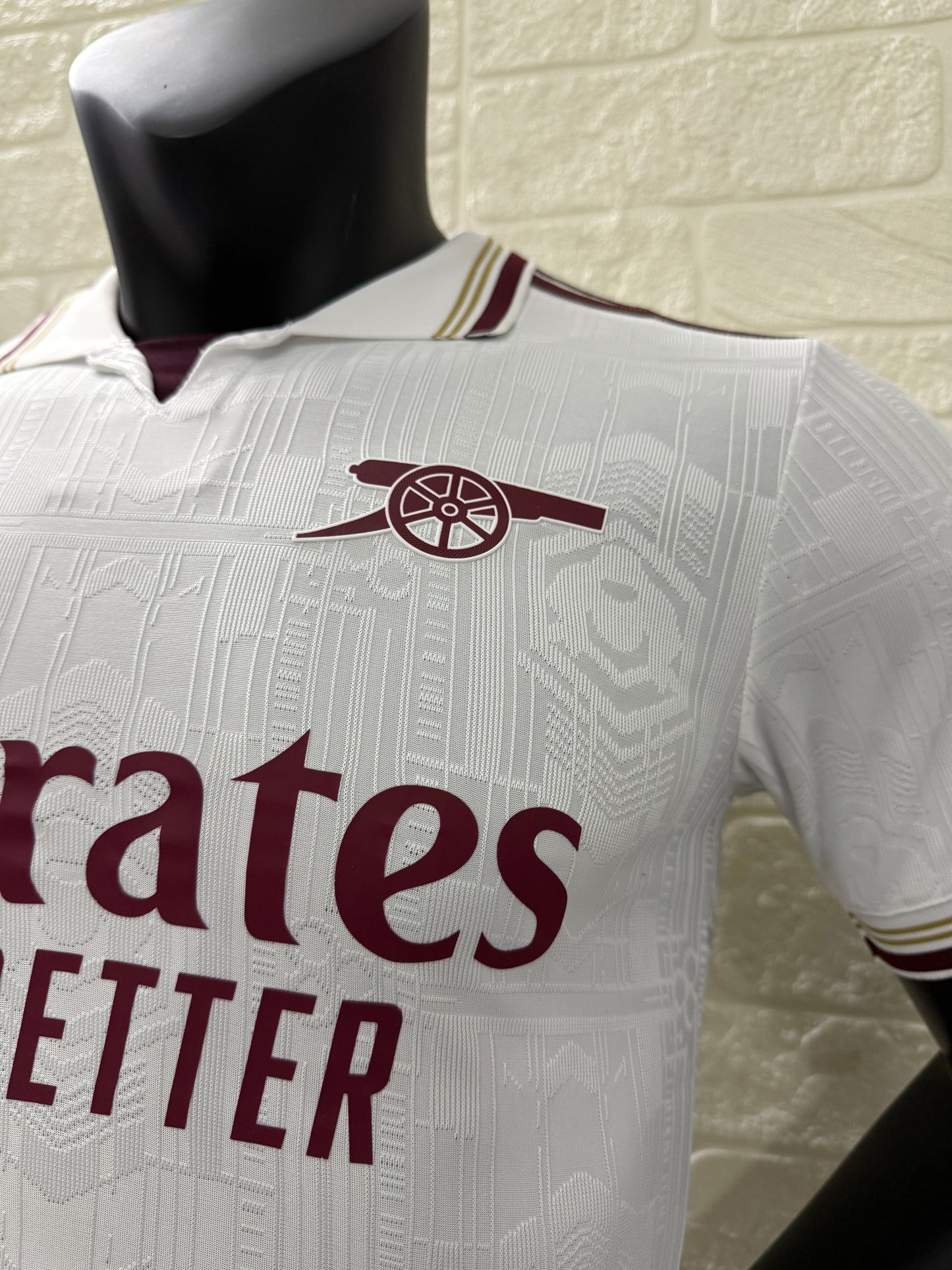 2025/26 Arsenal Third Player Version Jersey - White Body All-Over Subtle Tonal Graphic Texture Deep Maroon Polo Collar Gold Cream Stripe Trim Deep Maroon Sleeve Cuff Trim - Originals Trefoil - Arsenal Cannon Crest - Emirates Fly Better