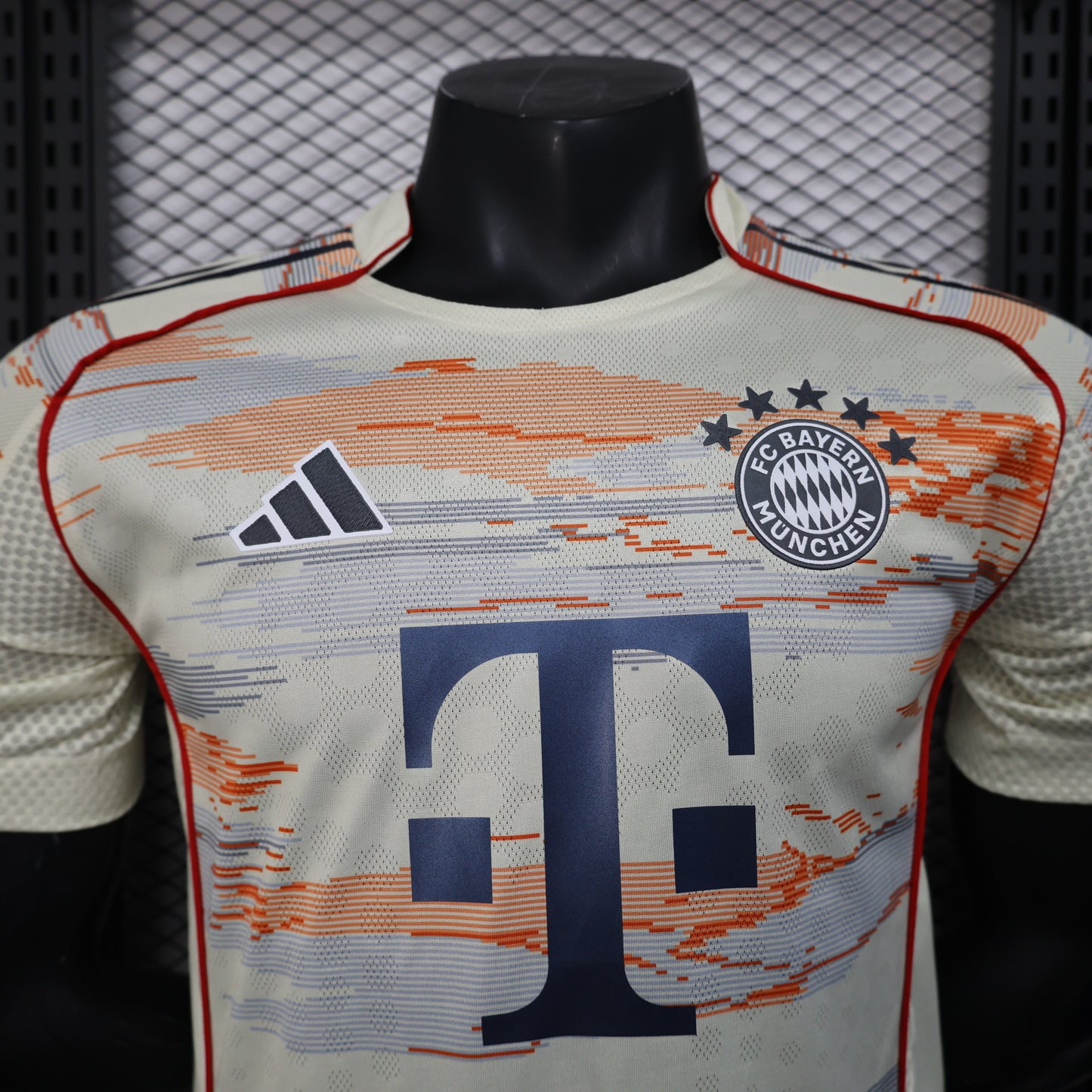 2025/26 Bayern Munich Away Player Version Jersey -  Body Orange Grey Horizontal Brush Stroke Graphic  - Red Side Seam Piping Red Sleeve Cuffs Black Shoulder Stripes - FC Bayern Crest - Deutsche Telekom T Logo