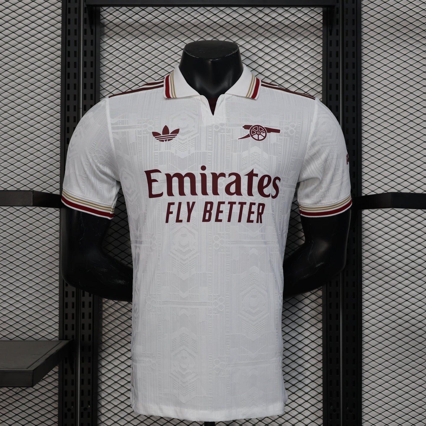 2025/26 Arsenal Away Player Version Jersey - White Body All-Over Tonal Emirates Stadium Architectural Line Emboss Pattern Deep Maroon Polo Collar Multi-Stripe Gold Red White Trim -Arsenal Cannon Crest - Emirates Fly Better