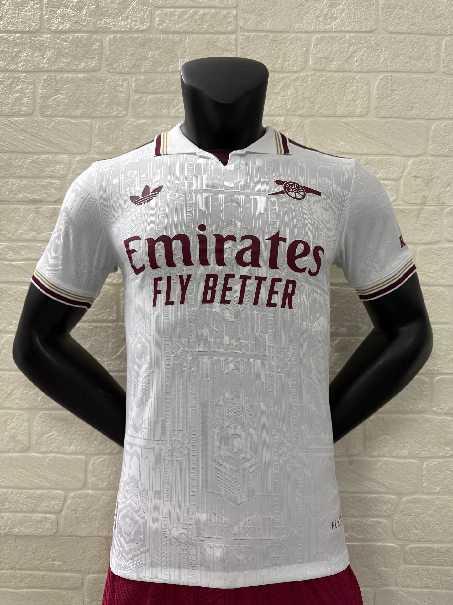 2025/26 Arsenal Third Player Version Jersey - White Body All-Over Subtle Tonal Graphic Texture Deep Maroon Polo Collar Gold Cream Stripe Trim Deep Maroon Sleeve Cuff Trim - Originals Trefoil - Arsenal Cannon Crest - Emirates Fly Better