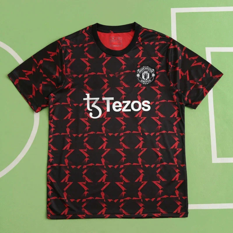 Manchester United Training Shirt Fan Version 2024/25 – Black Red Diamond Pattern Tezos Pre-Match Top