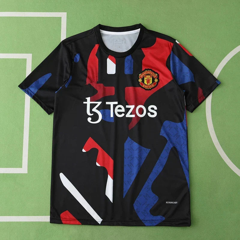 Manchester United Training Shirt Fan Version 2024/25 – Black Red Blue Geometric Tezos Pre-Match Top
