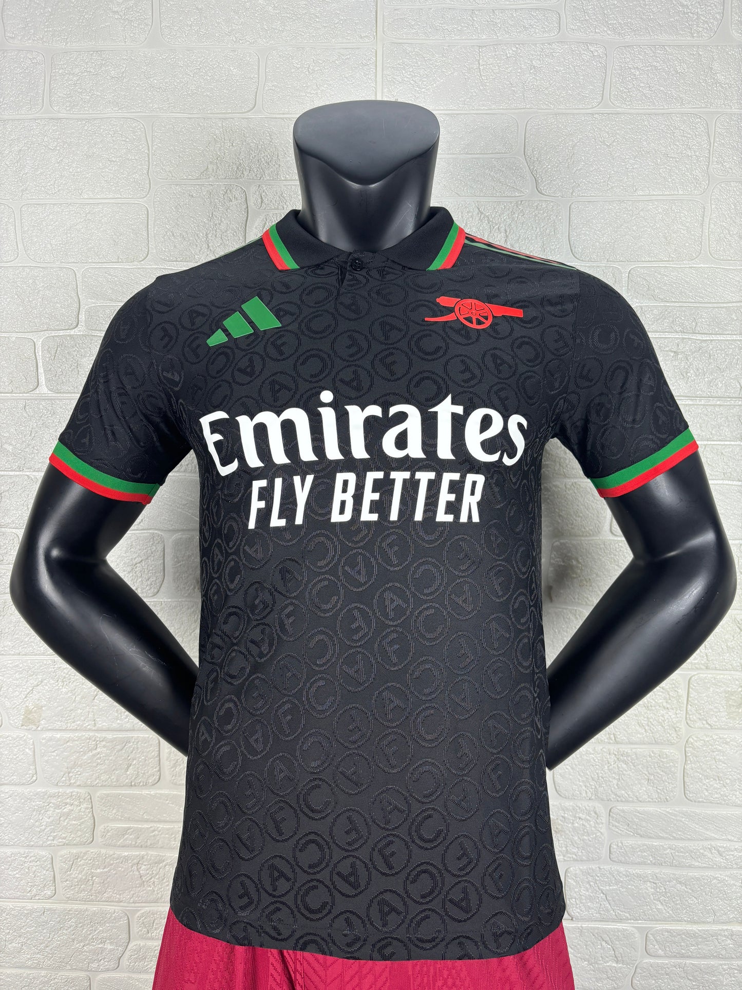 2025/26 Arsenal Special Edition Black Player Version Jersey - Black Body All-Over Tonal Cannon Circular Emboss Pattern Black Polo Collar Green Red Double Stripe Trim - Green Three Stripes - Red Arsenal Cannon Crest - Emirates Fly Better