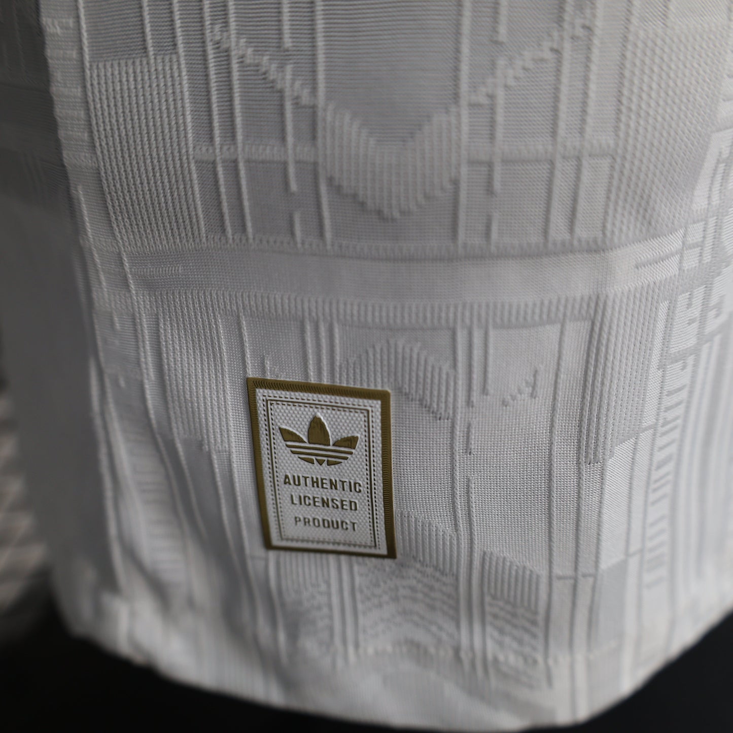 2025/26 Arsenal Away Player Version Jersey - White Body All-Over Tonal Emirates Stadium Architectural Line Emboss Pattern Deep Maroon Polo Collar Multi-Stripe Gold Red White Trim -Arsenal Cannon Crest - Emirates Fly Better