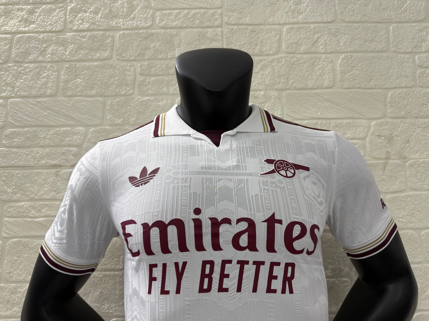 2025/26 Arsenal Third Player Version Jersey - White Body All-Over Subtle Tonal Graphic Texture Deep Maroon Polo Collar Gold Cream Stripe Trim Deep Maroon Sleeve Cuff Trim - Originals Trefoil - Arsenal Cannon Crest - Emirates Fly Better