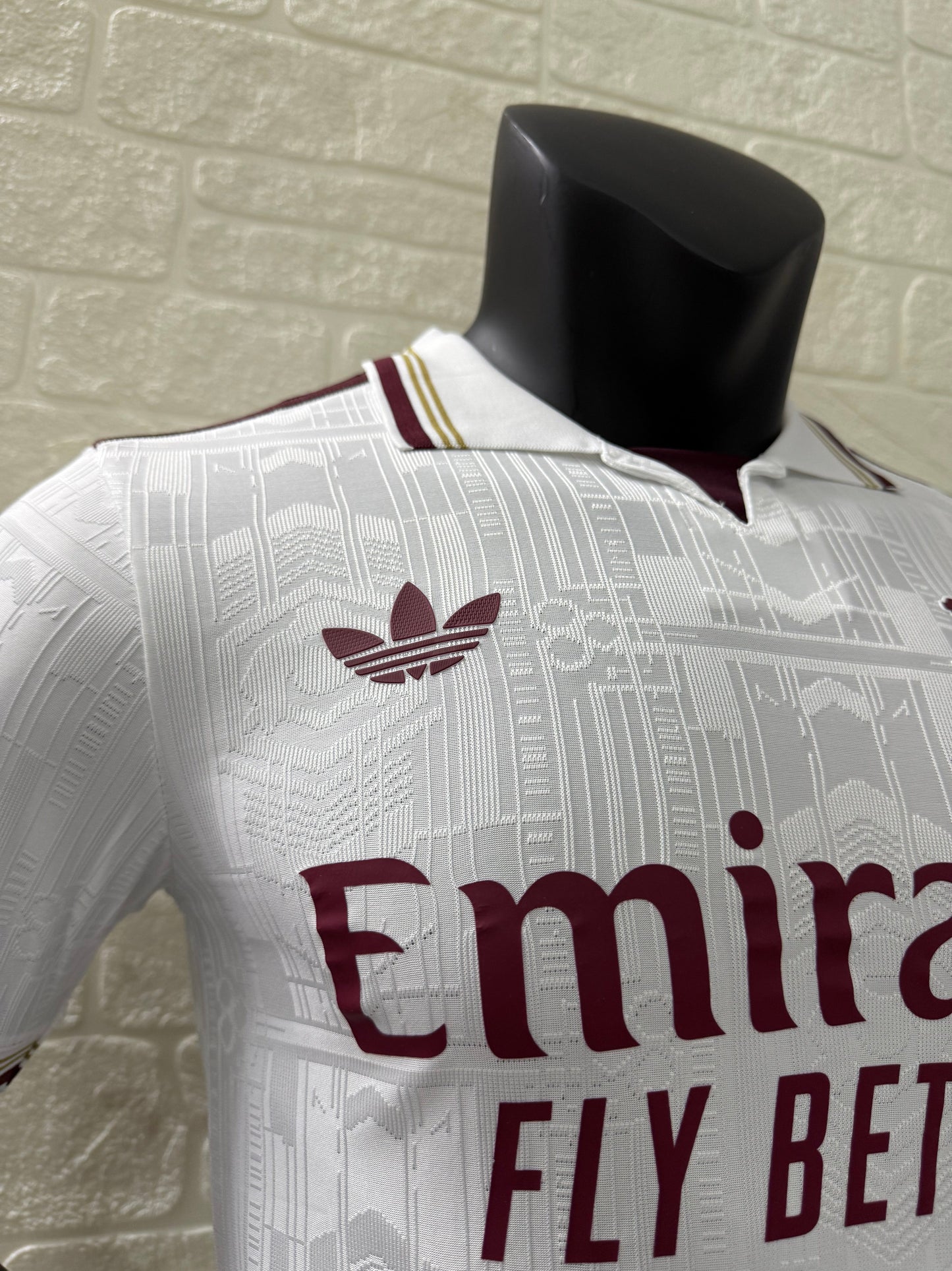 2025/26 Arsenal Third Player Version Jersey - White Body All-Over Subtle Tonal Graphic Texture Deep Maroon Polo Collar Gold Cream Stripe Trim Deep Maroon Sleeve Cuff Trim - Originals Trefoil - Arsenal Cannon Crest - Emirates Fly Better